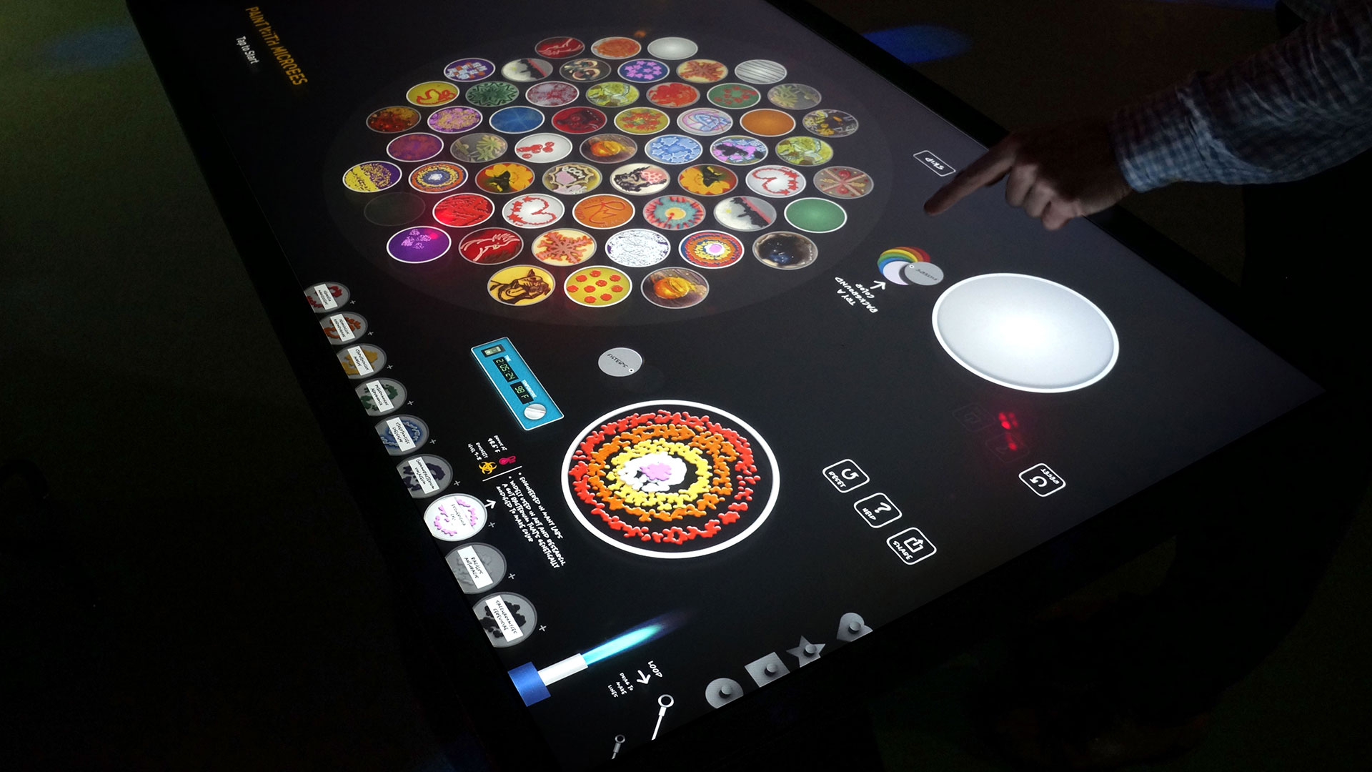 A large multitouch table interface allows up to four groups to create artworks in parallel.